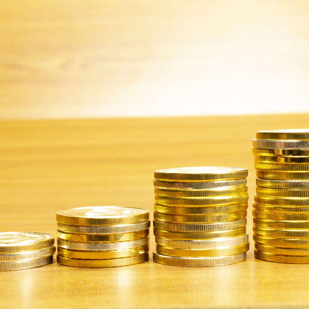 4 rows of coins arranged in ascending order with selective focus 4 rows of coins arranged in ascending order with selective focus and blurred background. Growth concept.